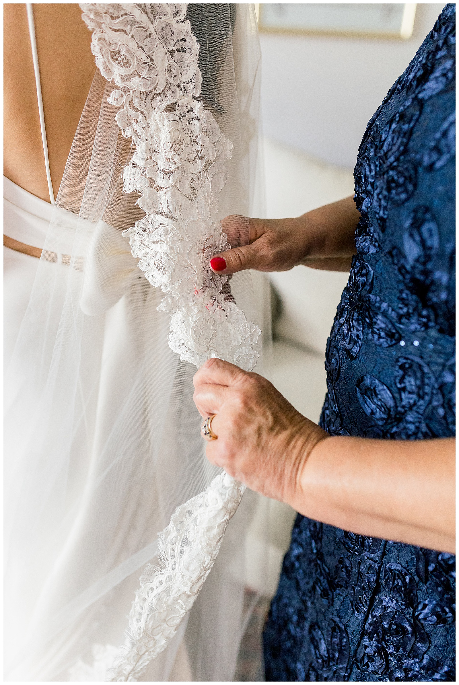 mother fixes brides veil
