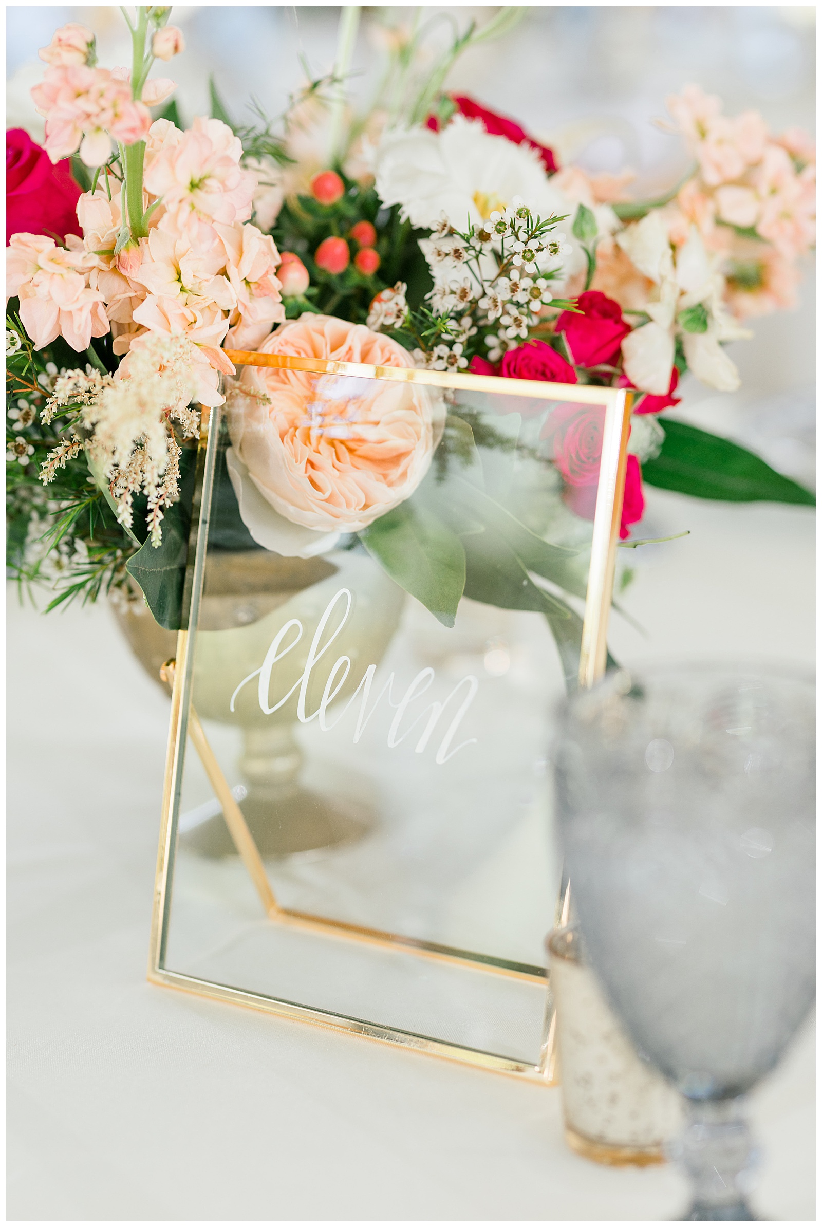 reception centerpiece flowers and gold framed acrylic table number
