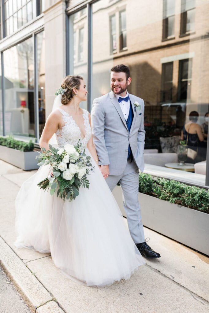 bride and groom walking together during portraits at Quirk Hotel Richmond