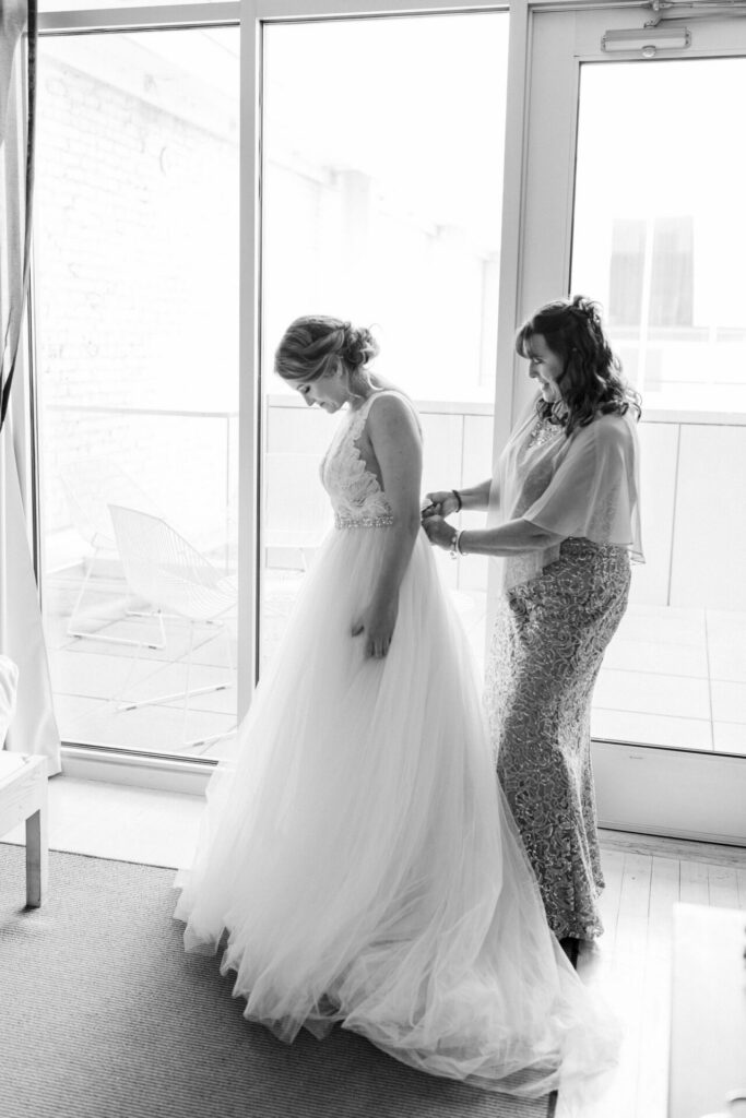 black and white mother zips up wedding dress at Quirk Hotel Richmond