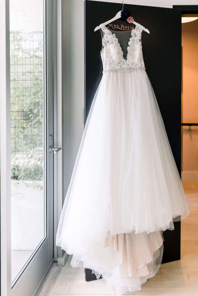 wedding dress hangs on room door at Quirk Hotel Richmond