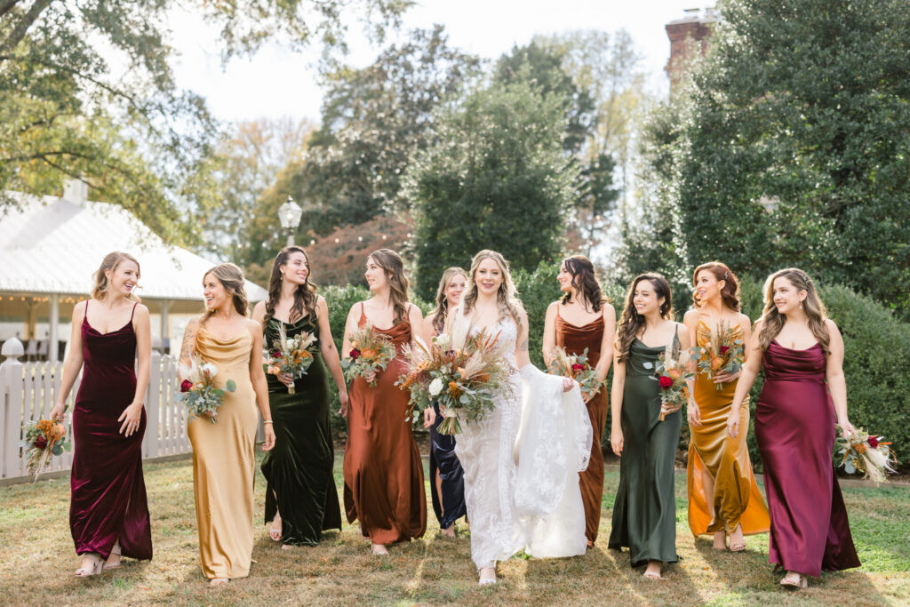 bride and bridesmaids walking in photo outside Seven Springs Richmond Va wedding