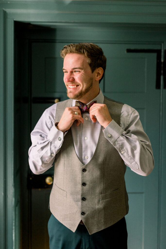 groom looking out window portrait Seven Springs Richmond wedding