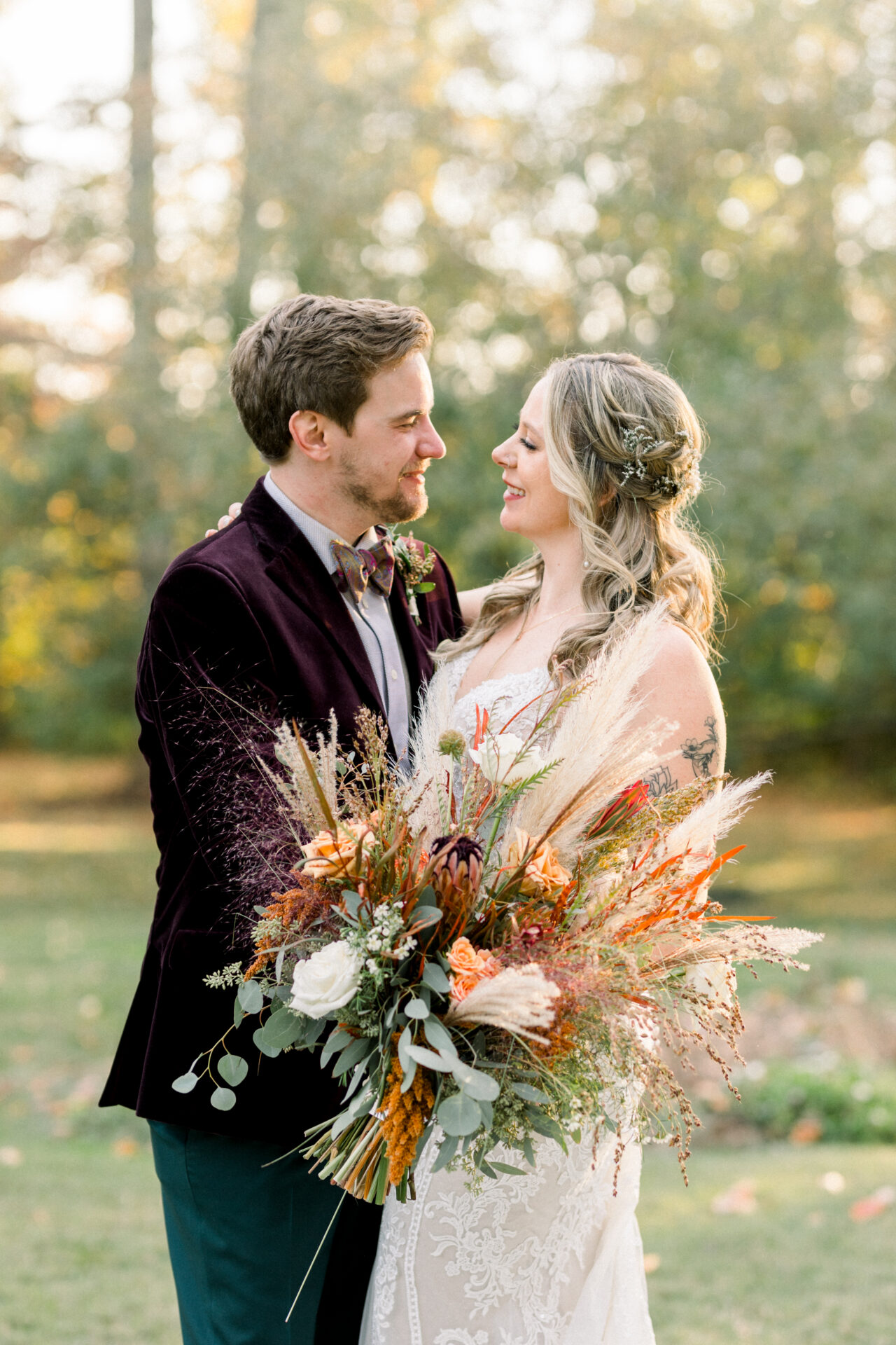bride and groom lookin at one another during golden hour portraits Seven Springs wedding Richmond Va