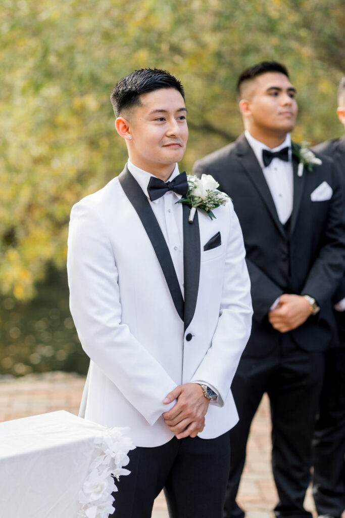 grooms smiles as bride walks down aisle Founders Inn Wedding Virginia Beach