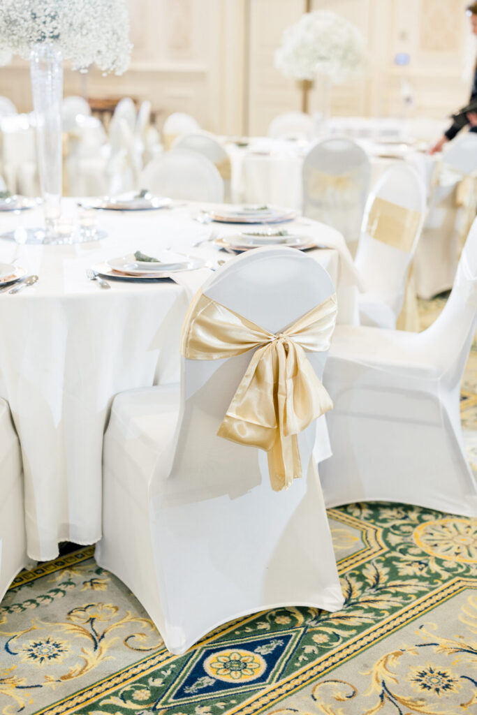 white reception chairs with champagne now