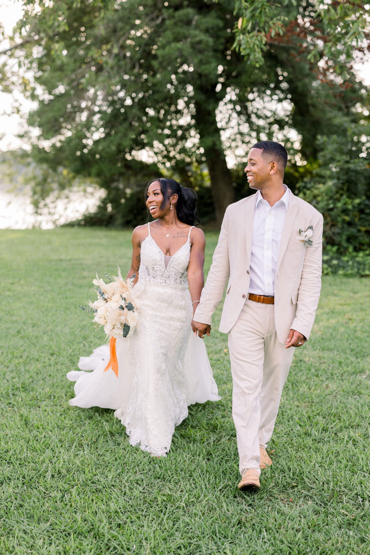 bride and groom walking together while holding hands wedding portraits Wiseacre Estate