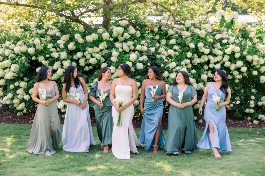 Bride and bridesmaids walking in front of hydrangea bush Virginia MOCA wedding photography